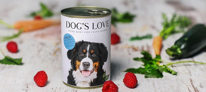 A can of DOG'S LOVE fish surrounded by carrots & raspberries
