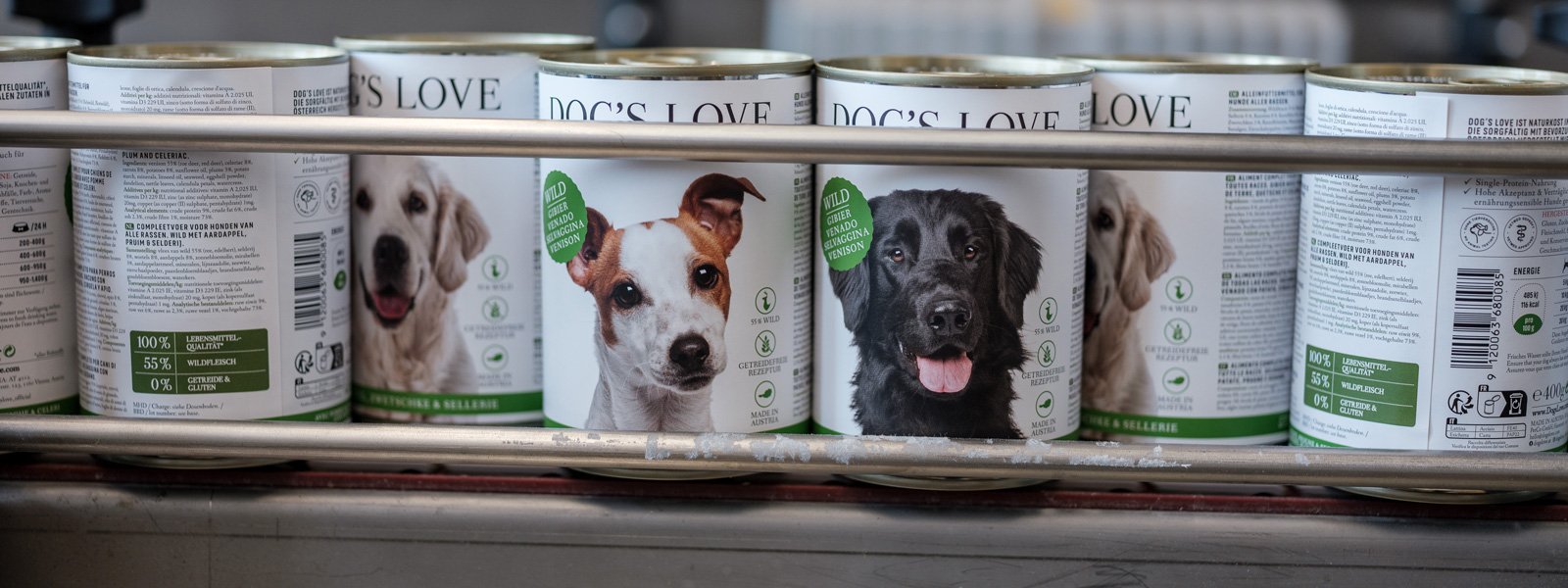 DOG'S LOVE cans running along a treadmill in the factory