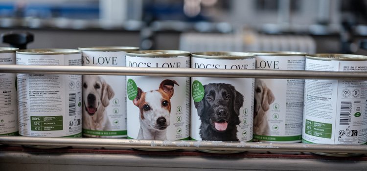 DOG'S LOVE cans running along a treadmill in the factory